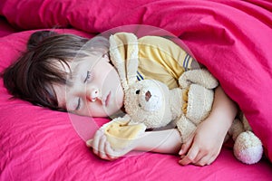 Sweet little boy, sleeping in the afternoon with his teddy bear