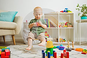 Sweet little boy on a small bench in his room