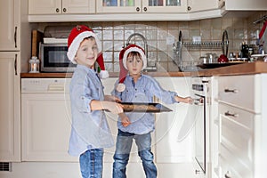 Sweet little children, boy brothers, preparing ginger bread cook