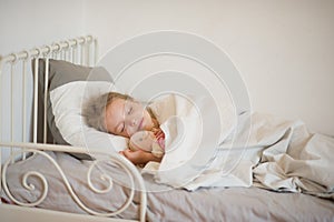 Sweet little girl asleep in her bed.