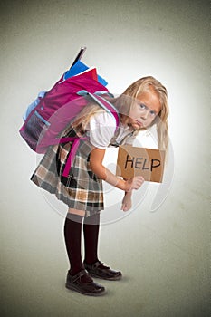 Sweet little girl carrying very heavy backpack or schoolbag full