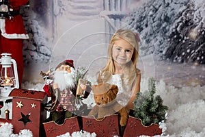 Sweet little girl with christmas decorations, playing