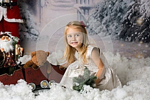 Sweet little girl with christmas decorations, playing