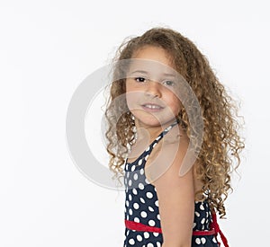 Sweet little girl with curly hair looking at camera
