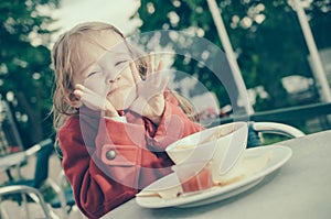 Sweet little girl having fun while eating