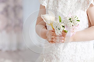 Sweet little girl holding  flowers in hands. Close up photo. Copy space