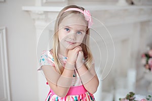 Sweet little girl holding her hands under her chin