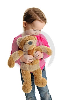 Sweet little girl holding a teddy bear
