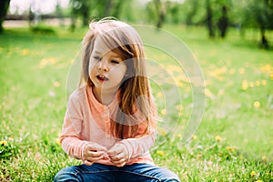 Sweet little girl outdoors with long hair.