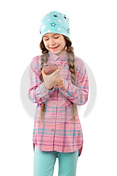 A sweet little girl playing games on her mobile phone isolated on white background