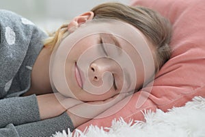 Sweet little girl sleeping in a bed