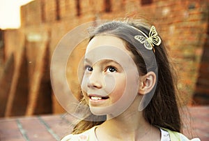 Sweet little girl thinking outdoors