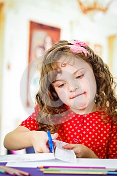 Sweet little girl using scissors