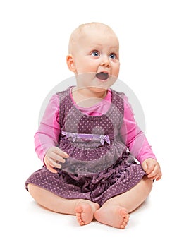 Sweet little girl in violet dress sits