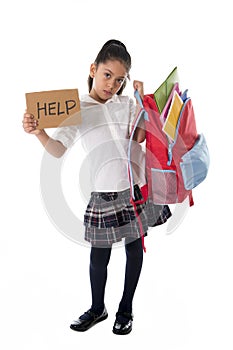 Sweet little latin school girl carrying heavy backpack or schoolbag full