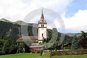 Sweet little Swiss parish church and churchyard photo