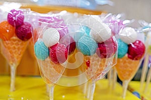 sweet lollipops Chupa Chups in transparent film on the counter photo