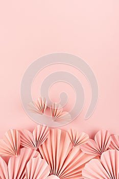 Sweet love background for celebrate wedding or Valentine day - gentle pink paper hearts flying on pink backdrop as footer border.