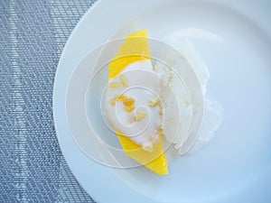 sweet mango with sticky rice with coconut milk on white plate