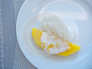 sweet mango with sticky rice with coconut milk on white plate