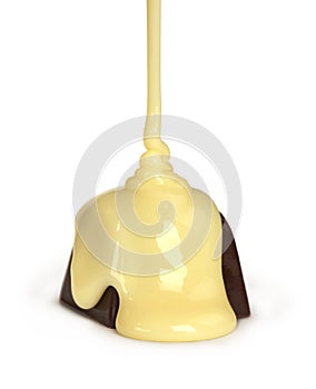 Sweet milk pouring on chocolate candy