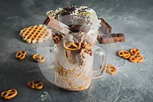 Sweet milkshake drink with dripping sauce, cookie and chocolate