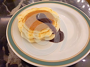 Sweet mini pancakes with chocolate syrup