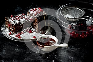 Sweet moments - sweet moments - brownies poured hot, liquid chocolate, sprinkled with red pomegranate seeds and powdered sugar