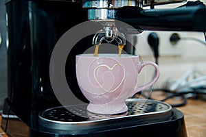 Sweet morning weekend at home - close up of coffee machine pouring espresso with soft background