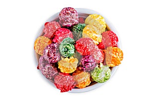 Sweet multicolor popcorn on a white isolated background