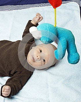 Sweet newborn baby with a soft toy