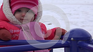 Sweet Newborn Baby Spinning on Carousel in a Winter Day. 4K UltraHD, UHD