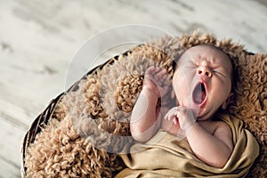 Sweet newborn baby yawns