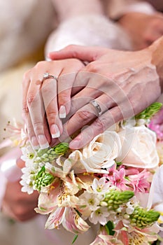 Sweet newly wed holding hands photo