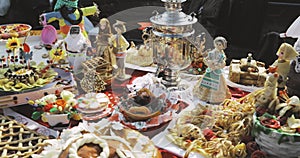 Sweet pastry and Russian samovar. Table with sweets, pancakes and pies. Traditional Russian tea drinking during