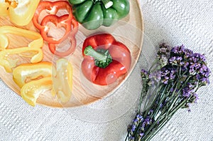 Sweet Pepper Cutting Sliced Preparation for Cooking. Raw Variety Red, Green, Yellow Sweet Peppers Slicing Chopped in Wooden Bowl