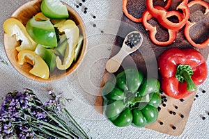 Sweet Pepper Cutting Sliced Preparation for Cooking. Raw Variety Red, Green, Yellow Sweet Peppers Slicing Chopped in Wooden Bowl