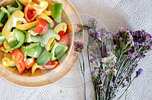 Sweet Pepper Cutting Sliced Preparation for Cooking. Raw Variety Red, Green, Yellow Sweet Peppers Slicing Chopped in Wooden Bowl