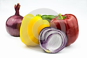 Sweet pepper, red, green and yellow, purple-red onion isolated on a white background