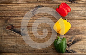 Sweet pepper on wood background, paprika, red, green and yellow sweet bell peppers on table
