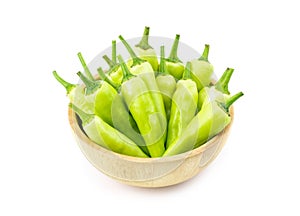 Sweet pepper in wooden bowl isolated on white background