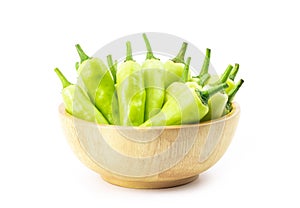 Sweet pepper in wooden bowl isolated on white background