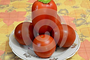 Sweet peppers with tomatoes on a plate. photo