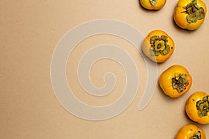 Sweet persimmon fruit on brown background