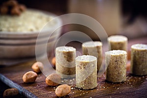 Sweet pieces peanut butter on a rustic table, called Brazilian PaÃ§oca