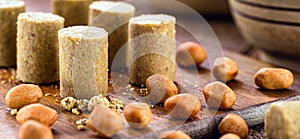 Sweet pieces peanut butter on a rustic table, called Brazilian PaÃ§oca