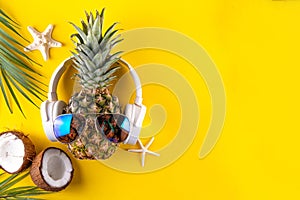 Sweet pineapple in sunglasses and headphones