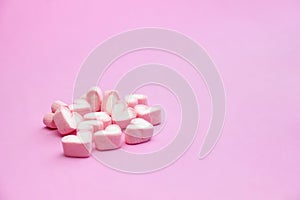 Sweet pink marshmallows on pink background with copy space