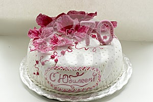 Sweet pink orchids white anniversary cake closeup