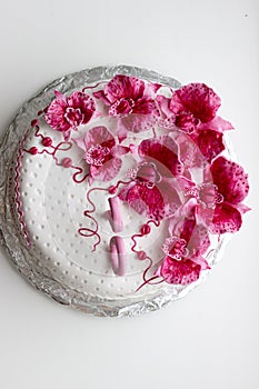 Sweet pink orchids white anniversary cake closeup